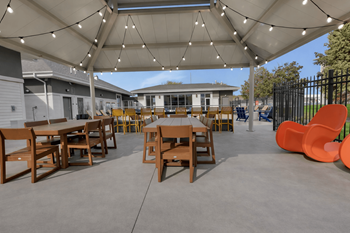Covered patio with string lights and wooden tables